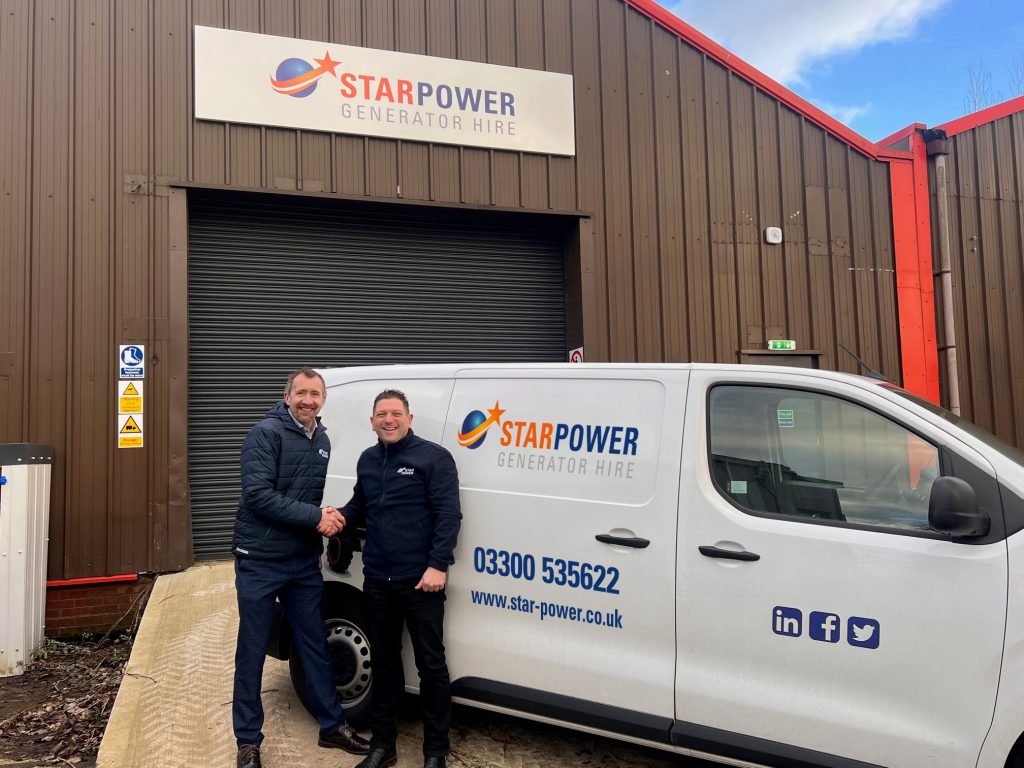 Star Power joins up with Star Platforms. A picture of two men shaking hands in front of a Star Power van and depot building