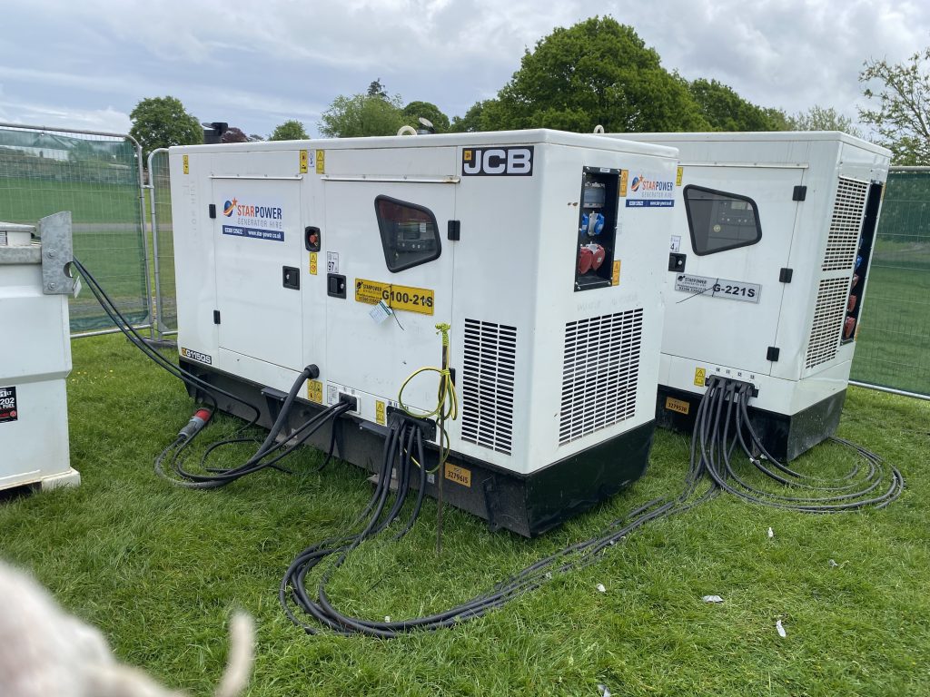 A JCB generator being hired in a field