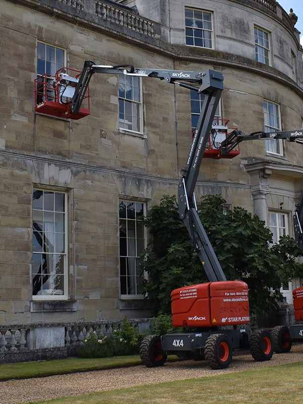Skyjack cherry picker boom lift used to clean windows at a stately home in the UK